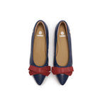 A pair of navy blue leather pointed-toe flats with red bow accents on the front, lambskin, comfortable, stylish