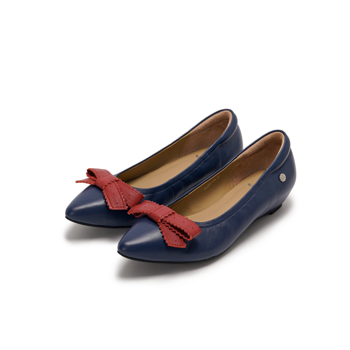 A pair of navy blue leather pointed-toe flats with red leather bow accents on the toes, lambskin, comfortable, stylish