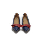 A pair of navy blue leather pointed-toe flats with a contrasting red leather bow detail on the vamp, lambskin, comfortable, stylish