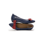 A pair of navy blue leather ballet flats with red bow accents on the toe, lambskin, comfortable, stylish
